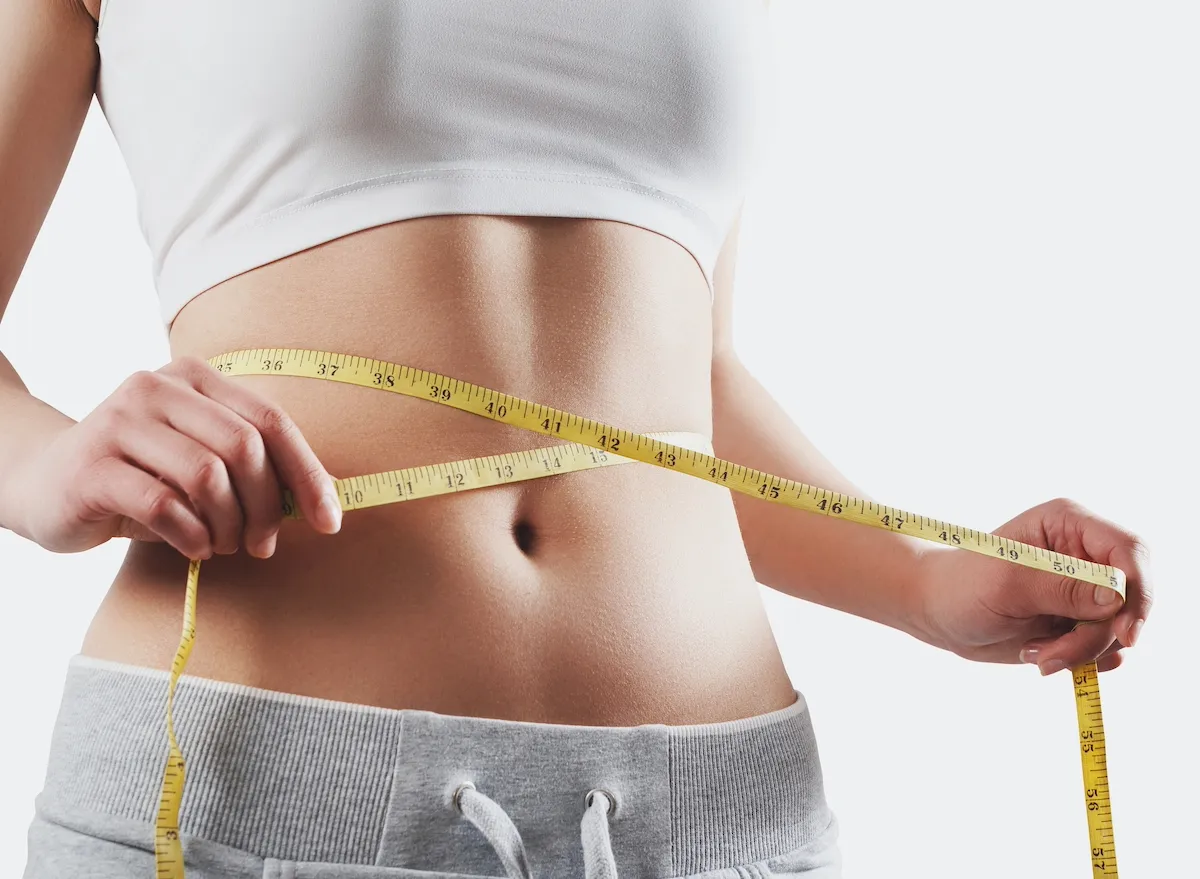 Measuring waist with a tape as part of a weight management journey